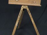 a small wooden tripod with a metal plate on top of it