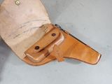 a leather case with a knife in it on the floor