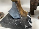 a statue of an axe on a marble block