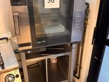 a large oven sitting inside of a kitchen next to a sink