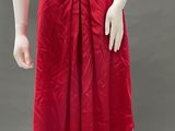 a mannequin wearing a red skirt with a bow around the waist