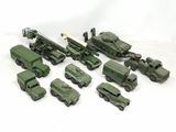 a lot of toy army vehicles and trucks on a white surface