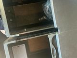 two microwaves that are sitting on top of each other
