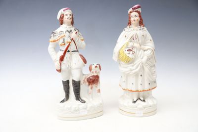 paire de figurines en porcelaine représentant un homme et une femme accompagnés d'un chien