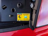 a red car with a yellow sticker on the front of it