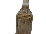 a small bottle with a glass top sitting on a table