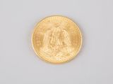 an image of a close up of a gold coin on a white surface