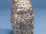 a close up of a silver object on a blue surface