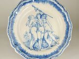 a blue and white plate with a picture of two people on it