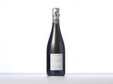 the bottle of wine is sitting on the table next to the bottle