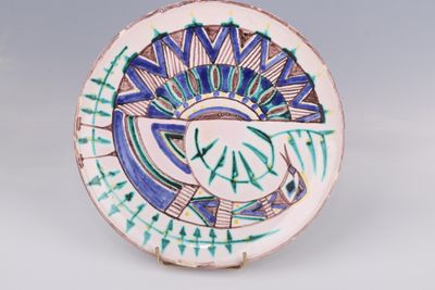 a plate with a design on it sitting on a table