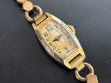 an image of a wrist watch with a gold bracelet