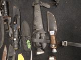 many different types of knives and knives laid out on the floor