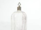 a clear glass bottle with a silver top
