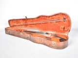 a violin case with a violin in it on a white surface