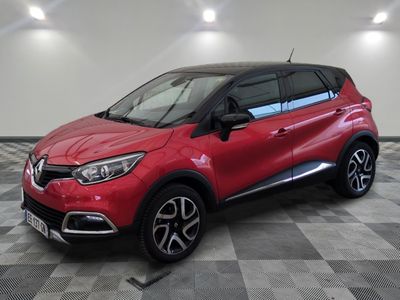 a red renault c - hr suv parked in a showroom
