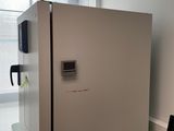 a refrigerator sitting on a desk in a room