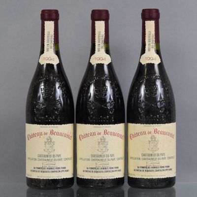 three bottles of wine are lined up on a table