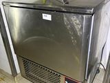 a stainless steel refrigerator in a kitchen with tile flooring