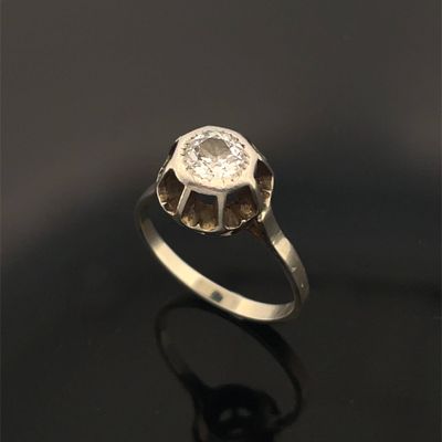 gros plan d'une bague en diamant sur une surface noire