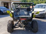 a yellow and black atv parked in a parking lot