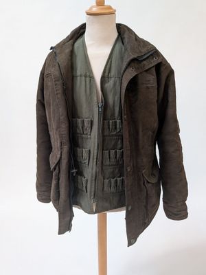 an image of a jacket on a mannequin stand on a white background