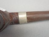 a pipe that is sitting on a table with a tag on it