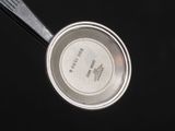 a metal pan with a lid and a spoon in it