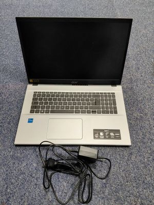 a laptop that is sitting on the floor with a charger