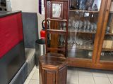 une armoire en bois avec une porte vitrée, dans un coin de la pièce