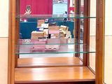 a display case with a glass door in a room