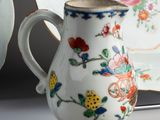 a white vase with a floral design on it