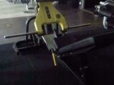 yellow and black gym equipment in a gym room with black flooring