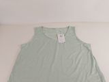 the tank top is green and has a white tag on it