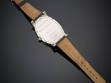 a close up of a watch on a black surface with a black background