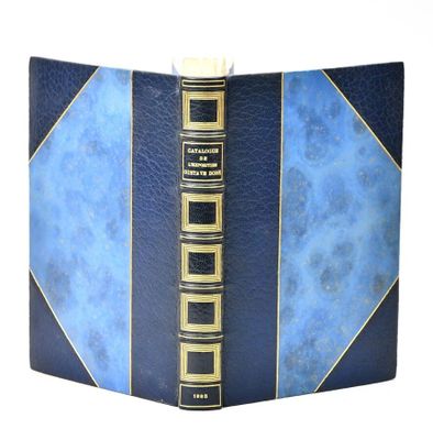 a blue book with gold trim and a blue cover