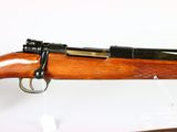 a rifle with a wooden barrel and a black muzzle on a white background