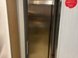 a silver refrigerator and a white freezer in a kitchen