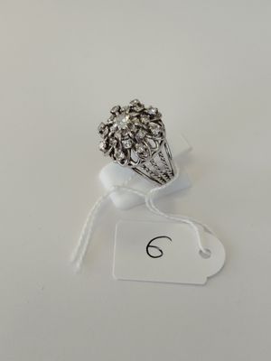 silver plated ring with a flower design on a white background