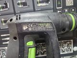 a close up of a corded drill in front of a panel