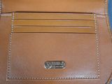 leather wallet with a card holder attached to it on a blue surface