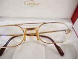 glasses in a box on a white cloth with a red ribbon