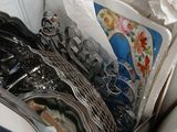 pile of kitchen utensils sitting in a box on a counter