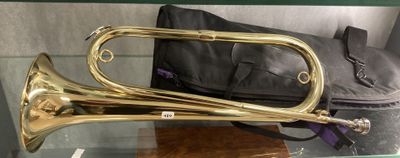 a brass trumpet sitting on a glass table