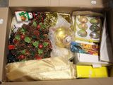 a cardboard box filled with christmas decorations and other holiday items