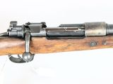 an old rifle with a wooden barrel and a metal handle