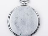 silver pocket watch on a white background with a green stone in the center