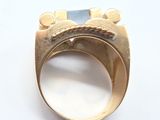 a gold ring with a blue stone in it