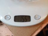 a digital scale on a table with a plastic bag on top