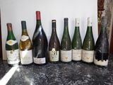 many bottles of wine lined up on the counter